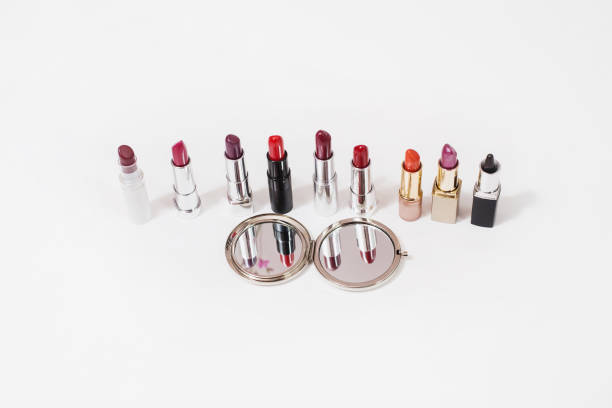 istock Multi-colored lipstick on white background. Reflection of lipstick in the mirror. Composition with makeup and a mirror. View from above. Concept. Decorative cosmetics, flat lay 684194962