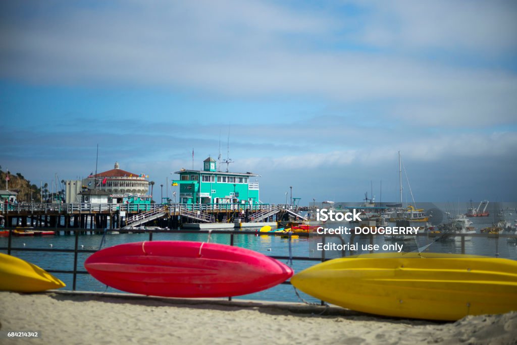 Catalina Island California The city of Avalon on the island of Catalina off the shore of Southern California, United States of America, May 13, 2017. Brightly colored sea kayaks can be seen in front of the Catalina pier with the Wrigley Casino in the background. California Stock Photo