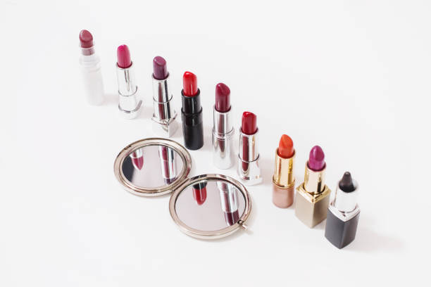 istock Multi-colored lipstick on white background. Reflection of lipstick in the mirror. Composition with makeup and a mirror. View from above. Concept. Decorative cosmetics, flat lay 684216954