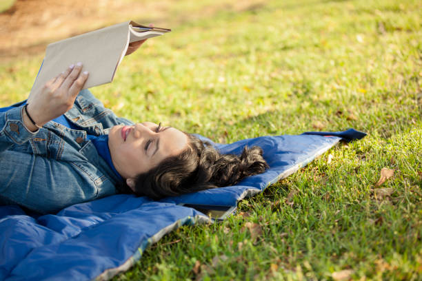 istock One Latin descent woman reading outdoors in park. 684253468