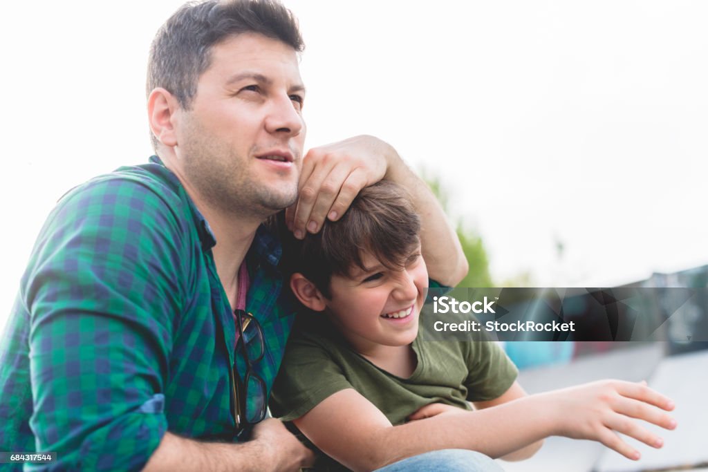 Just chillin with my dad Father and son having a good time in skate park Teenager Stock Photo