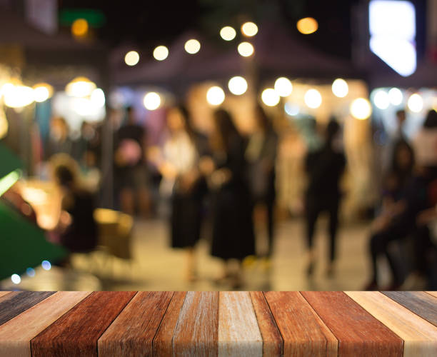 istock Wood table top on light bokeh,people shoping background 684359650