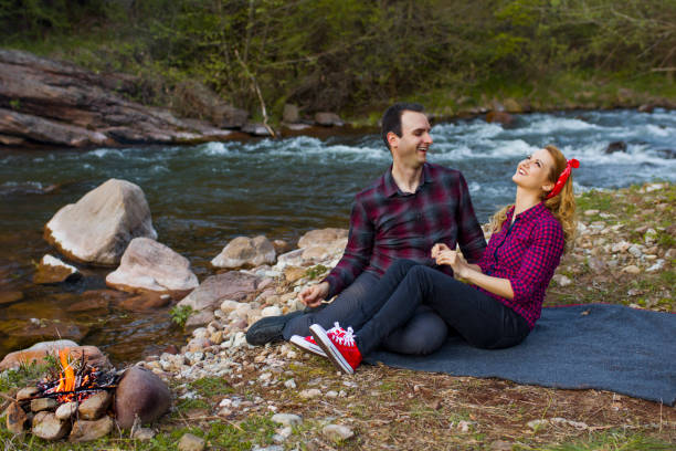 istock Beautiful couple sitting by the river 684359784