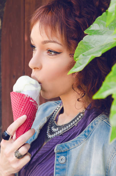 istock conceived a beautiful half-caste woman eating ice cream in a creative environment 684386970