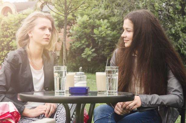 istock two friends drinking coffee in a cafe in nature 684388506