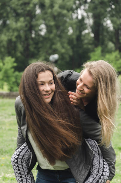 istock two friends to carry on their backs in nature 684389334