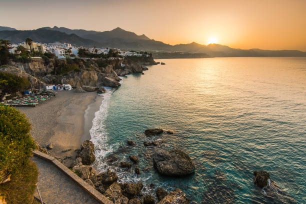 Beautiful sunrise over beach in Nerja,Andalusia,Spain stock photo
