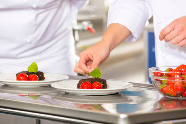 istock Professional chef decorate dessert cake with strawberry 684424270
