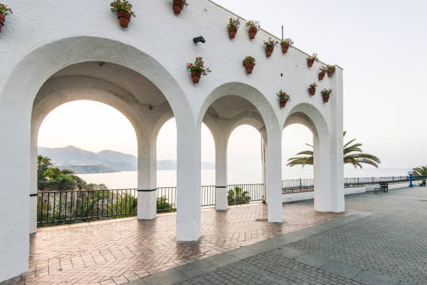 Warm sunlight bathes the buildings of sitges, spain, creating a nostalgic, analog-inspired cityscape at sunset