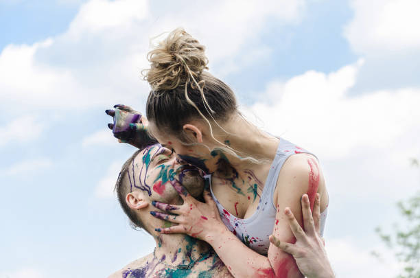istock boyfriend and girlfriend playing in nature and sprayed with water colors 684447904