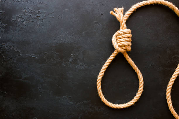 istock running knot of rope on a black background with space for text. Concept stop suicide 684450758