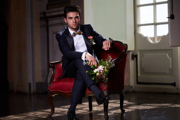 istock young groom waiting his bride on sofa 684451420