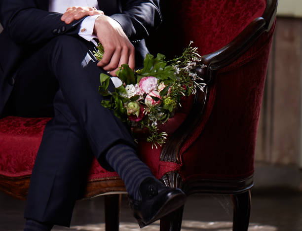 istock young groom waiting his bride on sofa 684452200