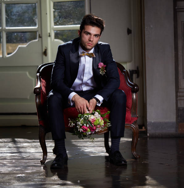 istock young groom waiting his bride on sofa 684454426