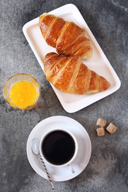 istock Two croissants, orange juice and coffee 684454710
