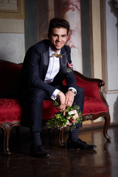 istock young groom waiting his bride on sofa 684454840