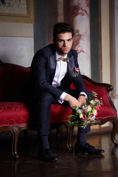 istock young groom waiting his bride on sofa 684454902