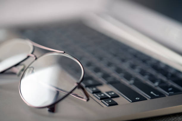 istock Glasses lying on the laptop keyboard 684455096