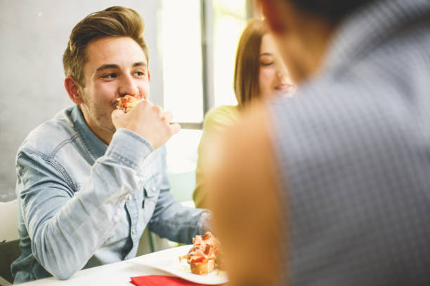 istock Young man eating with his friends 684467674