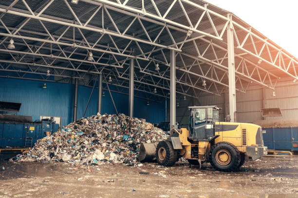 le bulldozer nettoiera la décharge de déchets. usine de traitement des déchets. processus technologique. entreprise de tri et de traitement des déchets. - pollution free photos et images de collection