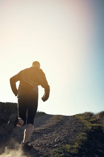 istock Man fell running in remote hillside location. 684471050