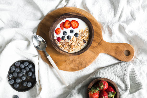 istock Oatmeal with strawberries and blueberries on a white sheet 684471132