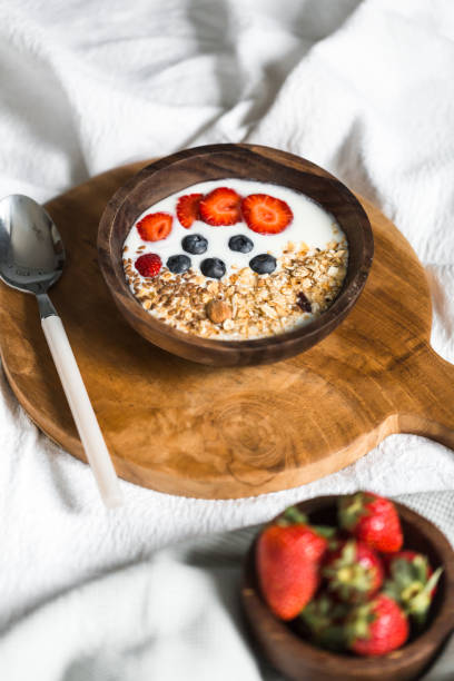 istock Oatmeal with strawberries and blueberries on a white sheet 684471750