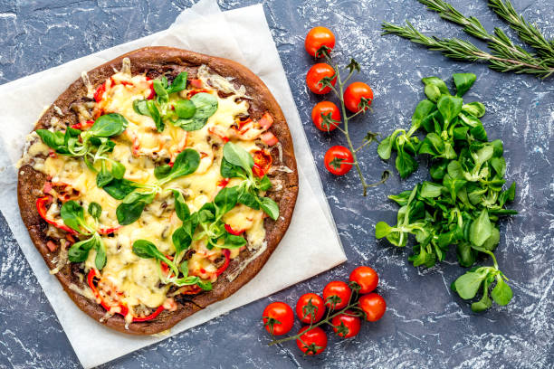 istock cooking pizza with vegetables and cheese on stone desk background top view 684474174