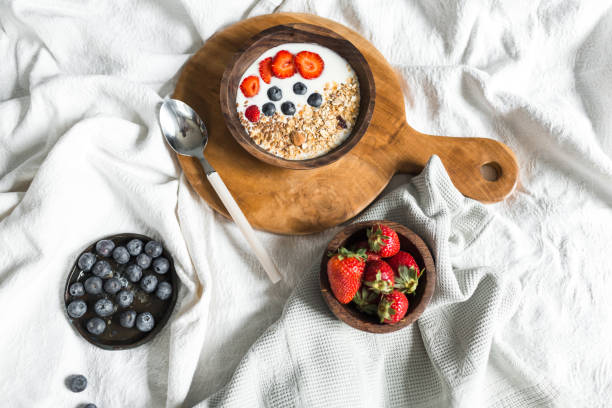 istock Oatmeal with strawberries and blueberries on a white sheet 684474508