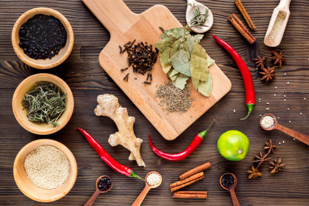 istock Spices, chili and herbs on wooden kitchen table background top view 684474712