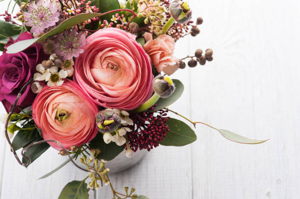 istock Bouquet of flowers in tin mug on light background 684474986