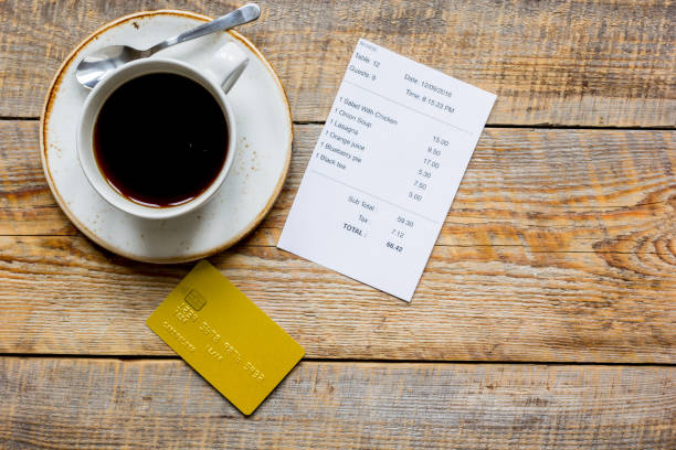 credit card for paying, coffee and check on cafe wooden desk background top view mock up credit card for paying, cup of coffee and check on cafe wooden desk background top view mock up restaurant table layout stock pictures, royalty-free photos & images