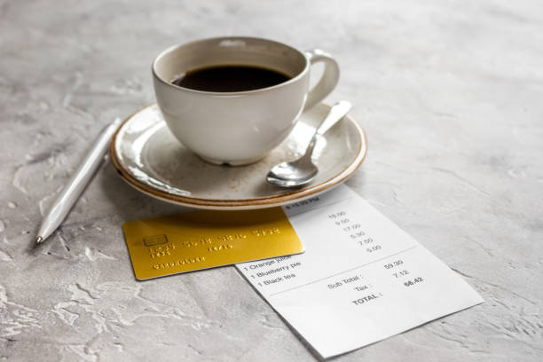istock coffee and receipt bill for payment by credit card on stone table background 684482290