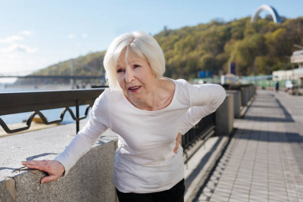 istock Suffering from back pain pensioner standing on the quay 684533160