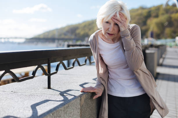 istock Distressing pensioner having headache in the street 684535436