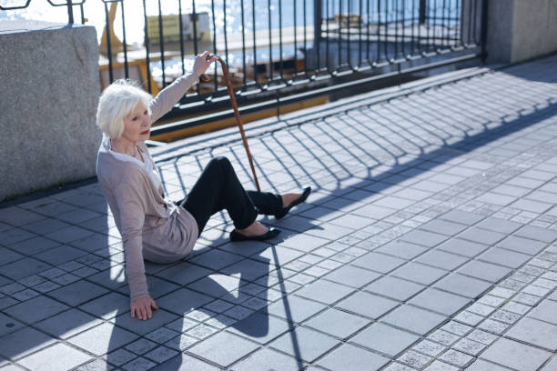 istock Sick elderly person waiting for help on the road 684535972