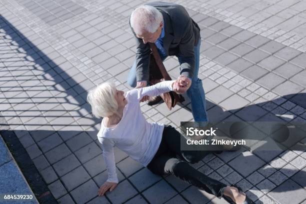 Pleasant Woman Tumbling Over Outdoors Stock Photo - Download Image Now - Falling, Senior Men, Senior Women