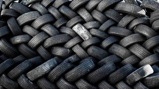 used auto tires stacked in piles stock photo