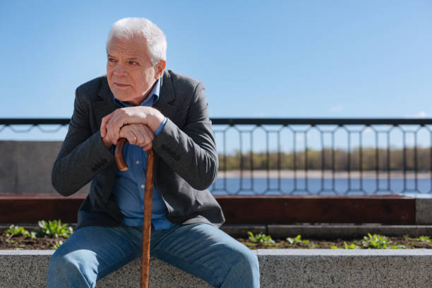 istock Brooding pensioner peering into the distance in the park 684539678