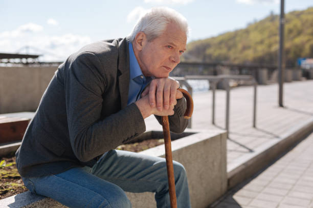 istock Lonely pensioner observing all around outdoors 684540130