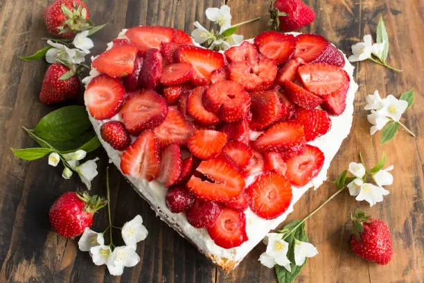 Heart Cheesecake with Strawberries  on Rustic Wooden Background.