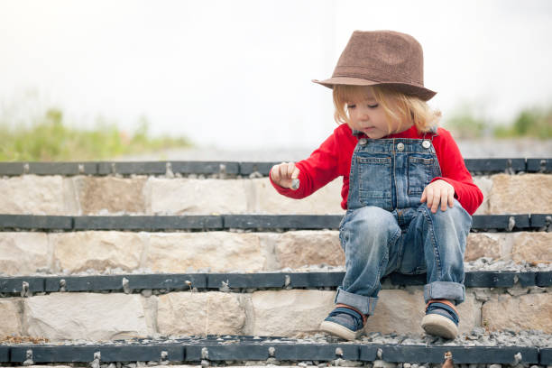 Young boy, with checkered cap, exploring petting zoo.\n\n\n\n\n\n\n\n\n
