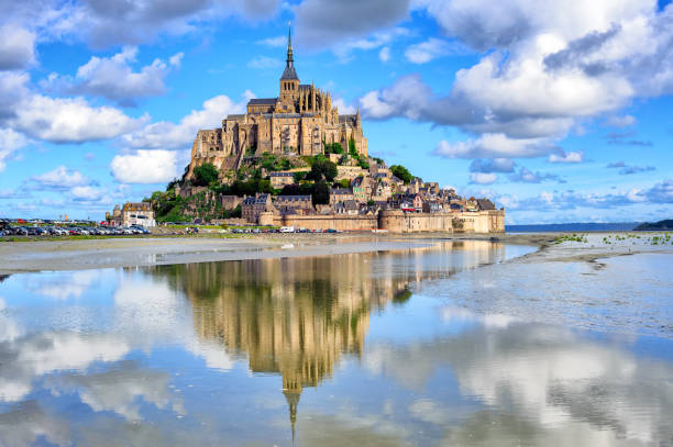 Le Mont-Saint-Michel island, Normandy, France Le Mont-Saint-Michel island with historical monastery reflecting in tidal water, Normandy, France mont saint michel photos stock pictures, royalty-free photos & images