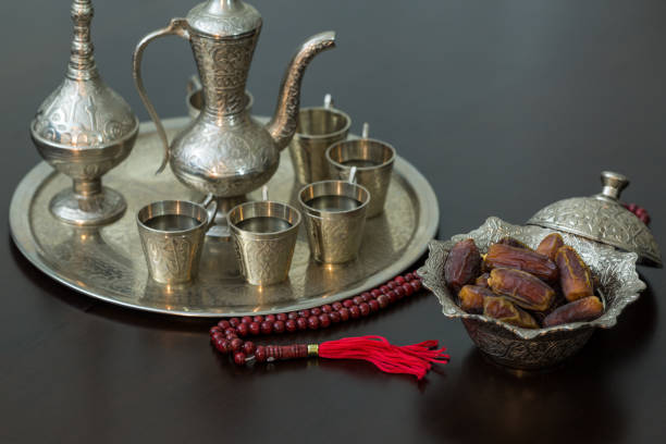 istock Ramadan concept: Dates, zam zam water and prayer beads on brown table 684552284