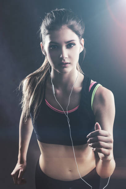 istock Jogging sportswoman with headphones 684559364