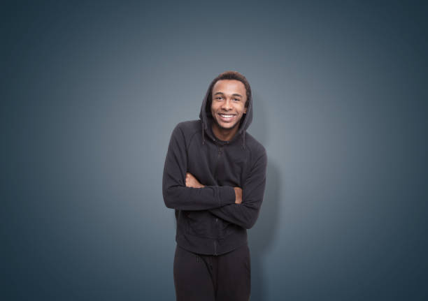 istock Smiling African man near a dark blue wall 684562484