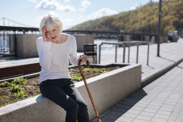 istock Ill pensioner having terrible pain in her head outside 684565304