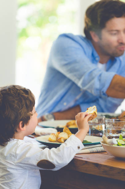istock Father and son eating together. 684595158