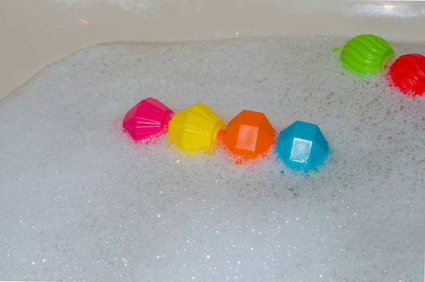istock Children's colorful toys floating in bubble bath. 684597836