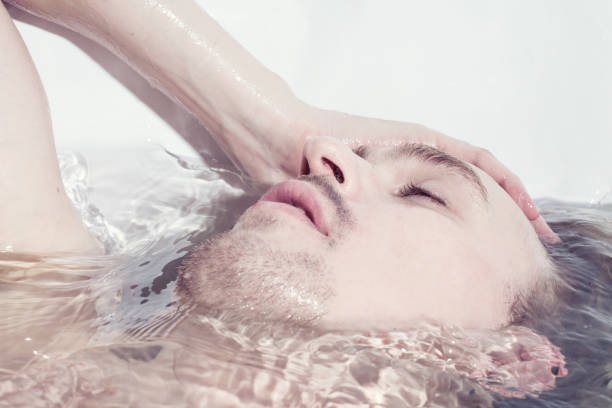 young sexual naked guy in bath close up